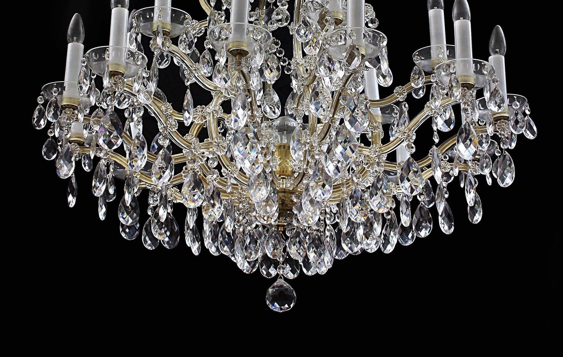 Crystal chandelier with gold accents on a black background