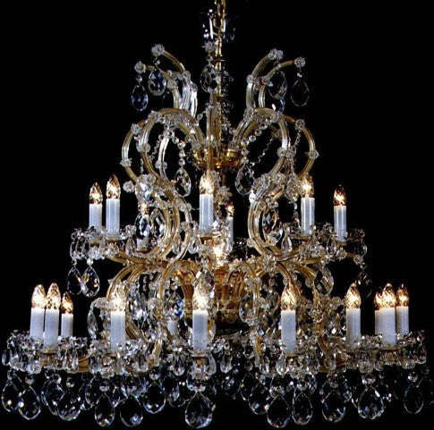 Ornate chandelier with multiple candle-like lights against a black background