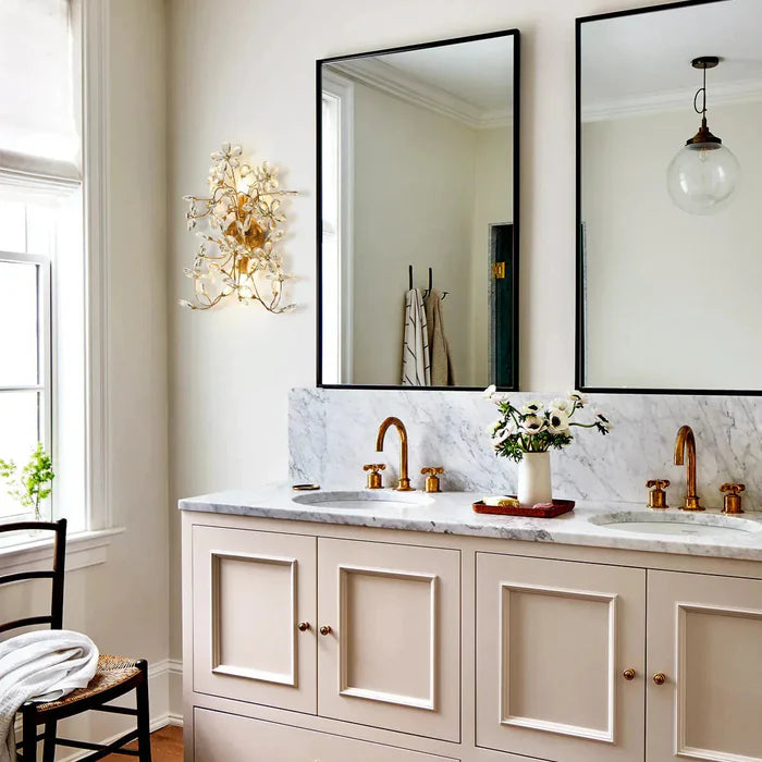 Bathroom vanity with marble countertop, mirrors, and decorative elements.