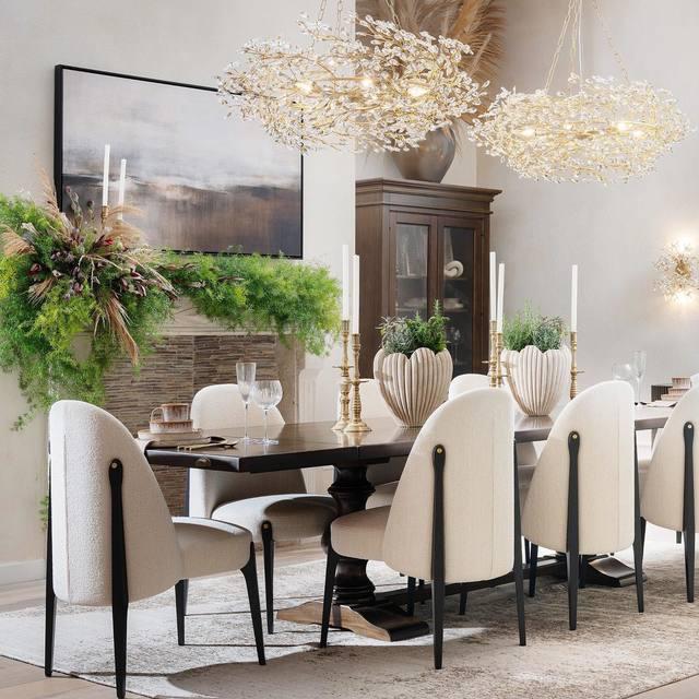 Elegant dining room with a black table, white chairs, and decorative elements.