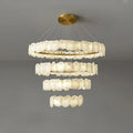 Chandelier with multiple tiers of round lights on a gray background